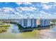 Beautiful waterfront condo building with lush landscaping and serene views at 10520 Boardwalk Loop # 504, Lakewood Ranch, FL 34202
