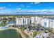 An aerial view showcasing a condo community with a pool, a well-kept landscape, and convenient parking by a lake at 10520 Boardwalk Loop # 504, Lakewood Ranch, FL 34202