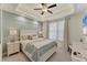 Bedroom features a queen bed, soft lighting, and cool wall color at 10520 Boardwalk Loop # 504, Lakewood Ranch, FL 34202