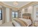 Cozy bedroom with neutral decor, tray ceilings, and views of the water at 10520 Boardwalk Loop # 504, Lakewood Ranch, FL 34202