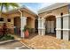 Clubhouse entrance featuring a well-maintained brick pathway and covered entryway at 10520 Boardwalk Loop # 504, Lakewood Ranch, FL 34202