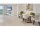 Bright dining area with modern table and views of the open-concept living space at 10520 Boardwalk Loop # 504, Lakewood Ranch, FL 34202