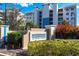 Waterfront community sign surrounded by lush landscaping and mature trees at 10520 Boardwalk Loop # 504, Lakewood Ranch, FL 34202