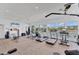 Light-filled gym with treadmills, weights, and a beautiful waterfront view at 10520 Boardwalk Loop # 504, Lakewood Ranch, FL 34202
