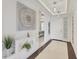 Stylish condo hallway with decorative niche, sleek lighting, and tiled floors leading to a bedroom at 10520 Boardwalk Loop # 504, Lakewood Ranch, FL 34202