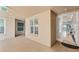 Hallway with neutral colors and large windows, leading to an outdoor area with seating and views at 10520 Boardwalk Loop # 504, Lakewood Ranch, FL 34202