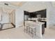 Modern kitchen featuring black cabinetry, stainless steel appliances, and a quartz island with barstool seating at 10520 Boardwalk Loop # 504, Lakewood Ranch, FL 34202
