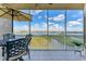 Screened lanai features beautiful lake views, table, and seating at 10520 Boardwalk Loop # 504, Lakewood Ranch, FL 34202