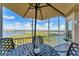 Screened lanai features beautiful lake views, table, and seating at 10520 Boardwalk Loop # 504, Lakewood Ranch, FL 34202