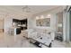 Modern living room featuring neutral tones, tile flooring, and views into the open kitchen at 10520 Boardwalk Loop # 504, Lakewood Ranch, FL 34202