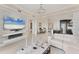 Bright, open-concept living room with a fireplace, and views into the kitchen and dining area at 10520 Boardwalk Loop # 504, Lakewood Ranch, FL 34202