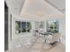 Elegant lobby with modern lighting, sleek seating, tiled floors, and large windows offering views of lush landscaping at 10520 Boardwalk Loop # 504, Lakewood Ranch, FL 34202