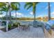 Enjoy outdoor cooking with a built-in grill and dining area, perfect for entertaining with a lake view at 10520 Boardwalk Loop # 504, Lakewood Ranch, FL 34202