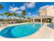 Inviting community pool surrounded by palm trees and lounge chairs, perfect for relaxation and enjoyment at 10520 Boardwalk Loop # 504, Lakewood Ranch, FL 34202