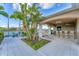 Tranquil poolside patio area with comfortable seating and lush tropical landscaping at 10520 Boardwalk Loop # 504, Lakewood Ranch, FL 34202