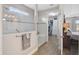 Bathroom with glass shower, handrail and view into a large walk-in closet and bedroom at 11050 Sandhill Preserve Dr, Sarasota, FL 34238