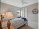 Comfortable bedroom featuring a ceiling fan, closet, and serene window view at 11050 Sandhill Preserve Dr, Sarasota, FL 34238