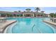 Relax in the community pool, steps away from the clubhouse and surrounded by lush landscaping at 11050 Sandhill Preserve Dr, Sarasota, FL 34238