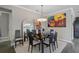 Dining area with a modern table set, decorative wall art, and a stylish light fixture at 11050 Sandhill Preserve Dr, Sarasota, FL 34238
