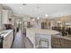 Spacious kitchen with an island and bar stool seating overlooks a formal dining area at 11050 Sandhill Preserve Dr, Sarasota, FL 34238