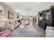 Open-concept living area boasts wood-look tile flooring and a view into the kitchen, creating an ideal space for entertaining at 11050 Sandhill Preserve Dr, Sarasota, FL 34238