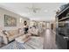 Spacious living room with wood-look tile floors and an open view to the kitchen, perfect for gatherings at 11050 Sandhill Preserve Dr, Sarasota, FL 34238