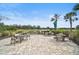 A beautiful outdoor seating area overlooks a serene lake, perfect for relaxing and enjoying the view at 11050 Sandhill Preserve Dr, Sarasota, FL 34238