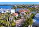 Aerial view of a luxury home with a tile roof, surrounded by water and lush landscaping at 1137 N Lake Shore Dr, Sarasota, FL 34231