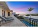 Relaxing outdoor balcony with waterfront views, lounge chairs, and wrought iron railings at 1137 N Lake Shore Dr, Sarasota, FL 34231