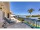 Inviting outdoor balcony with serene waterfront views, lounge chairs, and a pool below at 1137 N Lake Shore Dr, Sarasota, FL 34231