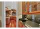 Convenient bar area with custom cabinetry, black countertop and sink, perfect for entertaining guests at 1137 N Lake Shore Dr, Sarasota, FL 34231