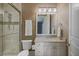 Elegant bathroom with textured walls, granite countertop vanity, and a glass-enclosed shower at 1137 N Lake Shore Dr, Sarasota, FL 34231