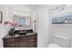 Elegant bathroom featuring a vessel sink, granite countertop, and a bamboo-framed mirror at 1137 N Lake Shore Dr, Sarasota, FL 34231