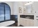 Well-lit bathroom featuring a modern vanity with black accents and elegant wall decor at 1137 N Lake Shore Dr, Sarasota, FL 34231