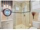 Bathroom featuring a glass shower, vanity with round mirror, and stylish tile work at 1137 N Lake Shore Dr, Sarasota, FL 34231