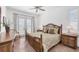 Serene bedroom with a rattan bed frame, neutral decor, and a private balcony entrance at 1137 N Lake Shore Dr, Sarasota, FL 34231