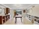 Bright bonus room with tiled floor, built-in shelving, and sliding glass doors to the pool area at 1137 N Lake Shore Dr, Sarasota, FL 34231