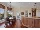 Dining room showcasing hardwood floors, large window views, a stylish chandelier and an adjacent bar area at 1137 N Lake Shore Dr, Sarasota, FL 34231