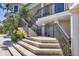 Elegant home exterior featuring stone steps, ornate metal railings, and lush tropical landscaping, creating a grand entrance at 1137 N Lake Shore Dr, Sarasota, FL 34231