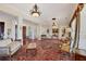 Grand foyer with staircase, columns, chandelier, and beautiful hardwood floors at 1137 N Lake Shore Dr, Sarasota, FL 34231
