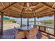 Inviting gazebo interior with comfortable seating, offering a serene waterfront view and a relaxing space to unwind at 1137 N Lake Shore Dr, Sarasota, FL 34231