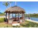 Charming waterfront gazebo with comfortable seating, providing a shady retreat with stunning water views and tropical breezes at 1137 N Lake Shore Dr, Sarasota, FL 34231