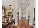 Hallway with hardwood floors, columns, chandeliers and view into the formal living room at 1137 N Lake Shore Dr, Sarasota, FL 34231