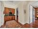 Hallway featuring hardwood floors, a bar with rich wood cabinetry, and a doorway to another room at 1137 N Lake Shore Dr, Sarasota, FL 34231