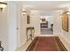 Inviting hallway with neutral walls, decorative lighting, and an ornate console table at 1137 N Lake Shore Dr, Sarasota, FL 34231