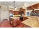 Gourmet kitchen with custom cabinetry, granite countertops, and stainless steel appliances with view to the living room at 1137 N Lake Shore Dr, Sarasota, FL 34231