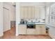 A charming kitchenette area featuring a blue countertop, white cabinets, and a microwave at 1137 N Lake Shore Dr, Sarasota, FL 34231