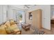 Cozy living room with a murphy bed, comfortable seating, and access to a private balcony at 1137 N Lake Shore Dr, Sarasota, FL 34231