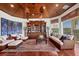 Elegant living area features custom wood ceiling, built-in bookcase, and comfortable seating arrangement with water views at 1137 N Lake Shore Dr, Sarasota, FL 34231