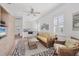 Inviting living room with a ceiling fan, comfortable seating, and a convenient kitchenette at 1137 N Lake Shore Dr, Sarasota, FL 34231